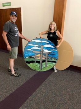 Cathy and husband with artwork